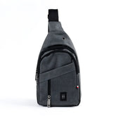 Gray textured fabric crossbody sling bag with black zipper pulls and small black logo patch