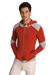 Form-fit crossover yoga track performance hoodie in cinnabar grey with contrasting red and gray panels and green zipper pull