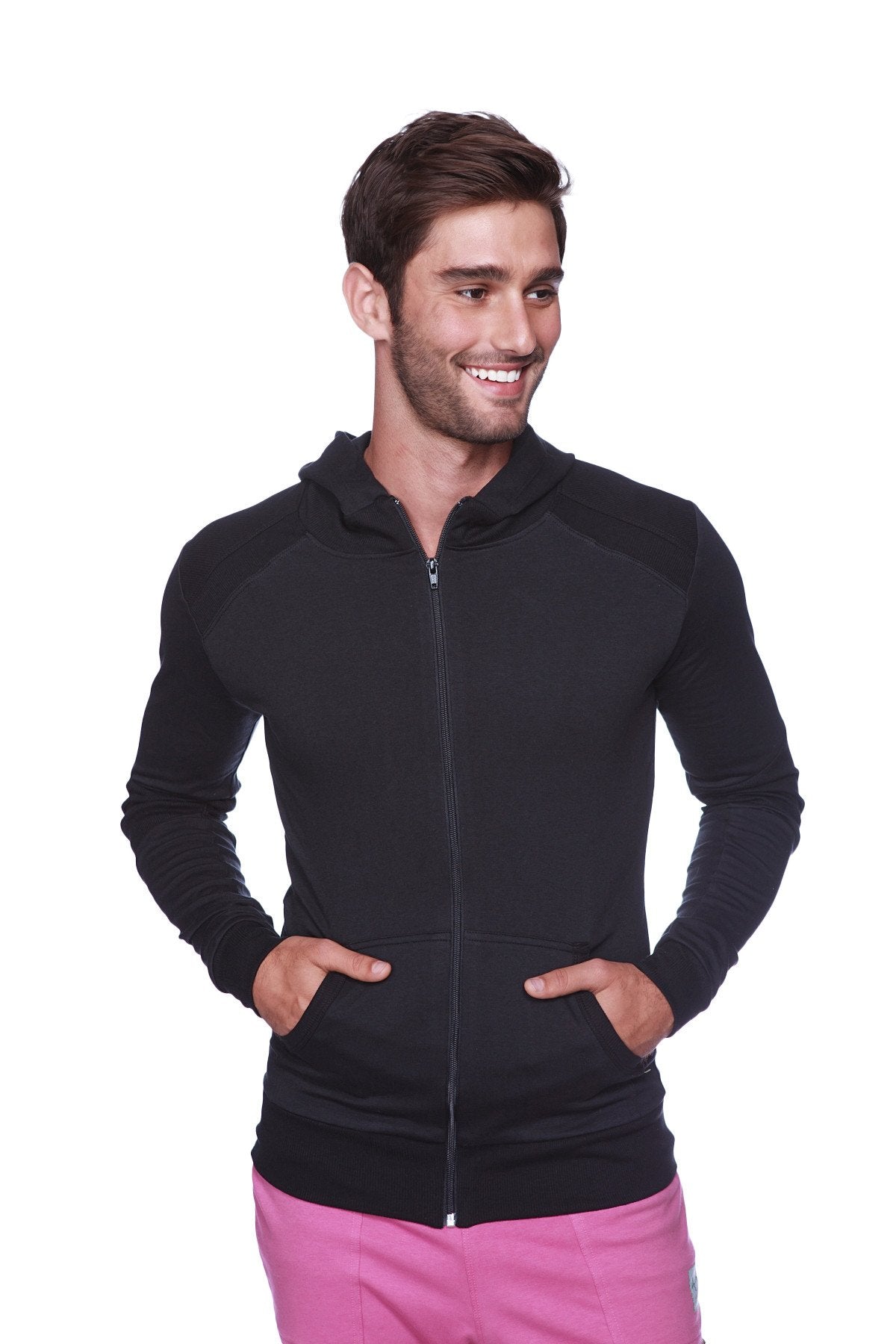 Form-fit crossover yoga track performance hoodie in solid black with black zipper paired with contrasting pink pants