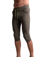 Cuffed yoga pants in army olive green with ribbed waistband and lime green drawstring for comfortable wear