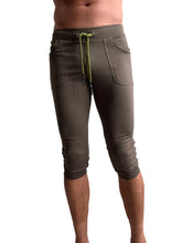 Olive green cuffed yoga pants with lime green drawstring and side pockets in capri-length jogger style
