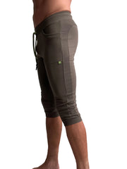 Olive green ribbed knit cuffed yoga capri pants with side pockets and drawstring waistband for comfortable wear