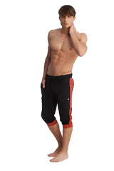 Black cuffed yoga pants with bold cinnabar side stripes and matching red cuffs designed for comfortable wear