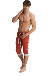 Red athletic shorts with white side stripes and matching drawstring designed for activewear and casual use