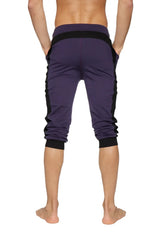 Cuffed yoga pants in eggplant with black side panels and elastic cuffs designed for athletic wear