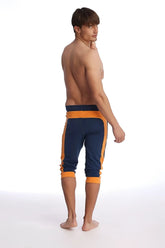 Navy blue and orange cuffed yoga pants with ribbed waistband and cuffs designed for athletic wear