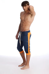 Navy blue and orange cuffed yoga capri pants with white drawstring designed for athletic wear