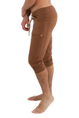 Brown cuffed yoga pants with drawstring waistband and side pockets made of comfortable fabric for athletic use