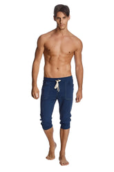 Navy blue cuffed yoga pants with white drawstring side pockets in capri-length jogger style for activewear