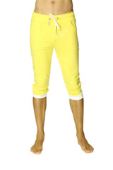 Bright yellow cuffed yoga pants with white drawstring and contrasting white cuffs in capri-length style