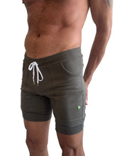 Cuffed yoga short in army green featuring olive green fabric with white drawstring and ribbed waistband and hem