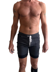 Dark gray cuffed yoga shorts with white drawstring and black trim at hem ideal for athletic and casual wear