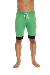 Cuffed yoga shorts in green with purple and black trim featuring white drawstrings designed for athletic use