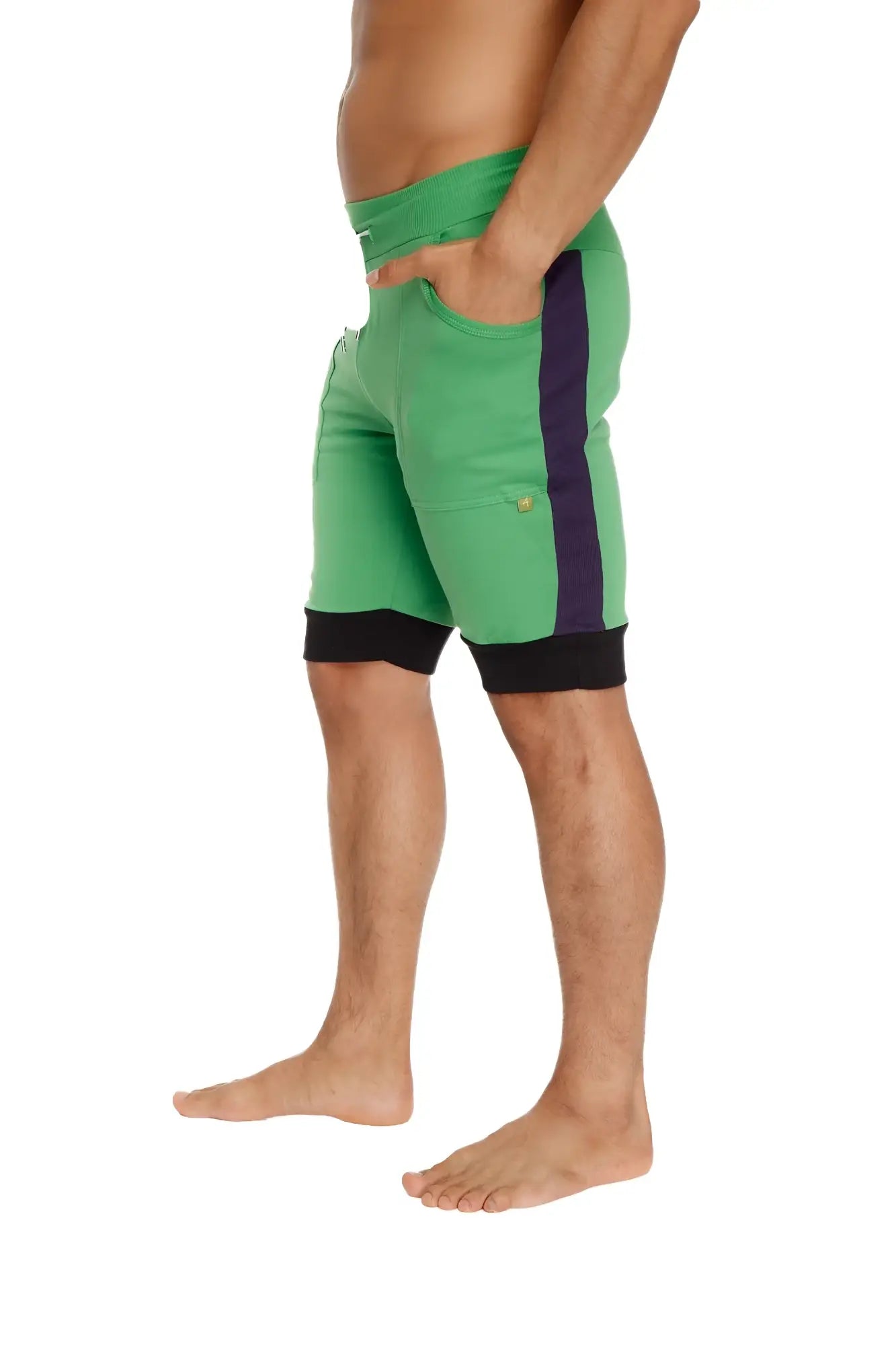 Green cuffed yoga shorts with purple side stripe and black waistband and hem trim for athletic use