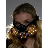Black and gold cyberpunk light up mask with glowing pink accents on circular filters for futuristic style