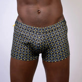 Black designer buckle print sq cut trunk swim trunks with bold yellow and light blue chain-link pattern