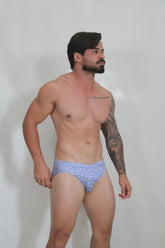 Designer print swim brief blue and white geometric patterned swim trunks for stylish beachwear and swimming
