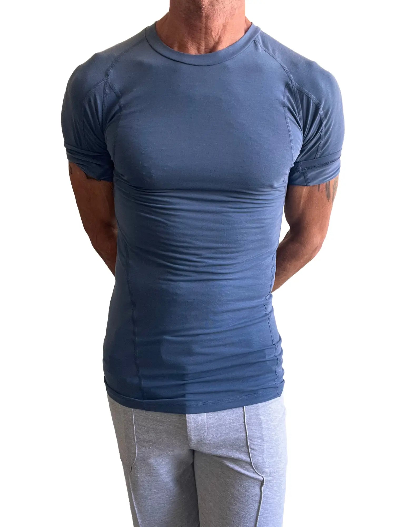Designer raglan crew-neck tee in denim blue featuring a fitted short-sleeved athletic design with raglan sleeves and seam detailing