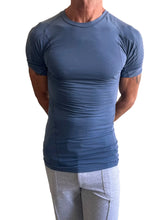 Designer raglan crew-neck tee in denim blue featuring a fitted short-sleeved athletic design with raglan sleeves and seam detailing