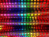 Disco queen tank featuring rainbow-colored holographic fabric with a grid of shimmering reflective squares