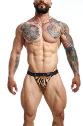 Black and orange tiger-striped DNGEON Peekaboo jockstrap briefs with black waistband, featuring animal print design