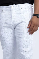 White denim dolorosa rhinestone jeans featuring a subtle pattern of small dark dots across the fabric
