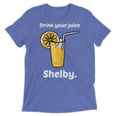Blue heathered t-shirt featuring a cartoon orange juice glass with lemon slice and straw and text drink your juice shelby