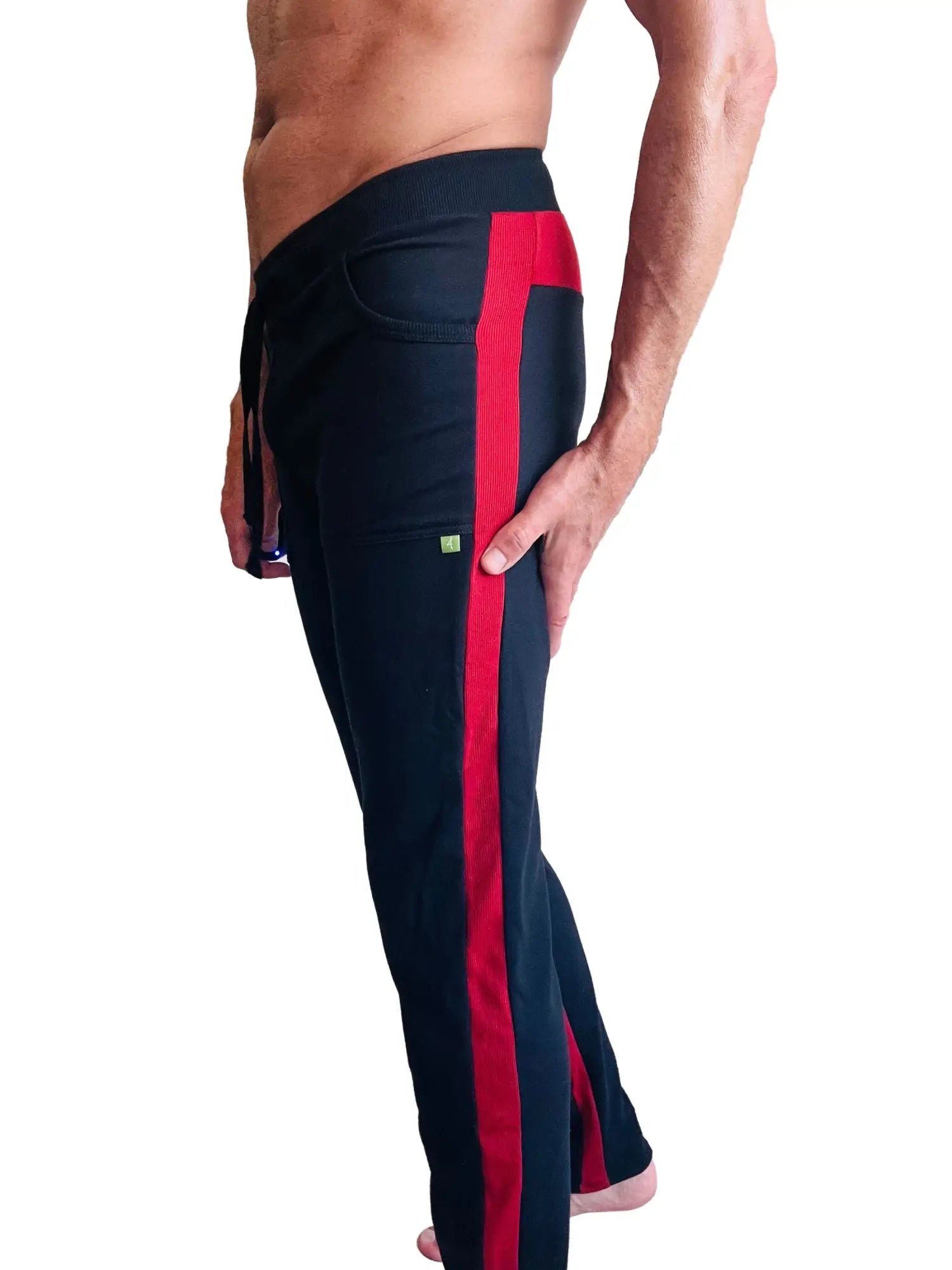 Black eco-track and yoga sweat pants with cinnabar red stripe, drawstring waist, and green logo on thigh