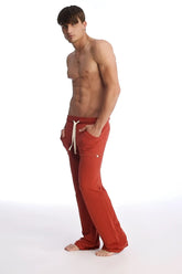Eco-track and yoga sweat pant in cinnabar featuring red athletic pants with white drawstrings and side pockets