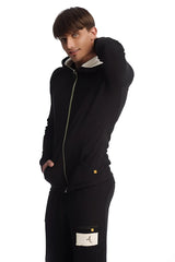 Edge form-fit crossover yoga track performance hoodie in black with contrasting light green zipper and white inner lining