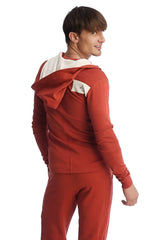 Back view of cinnabar red edge form-fit crossover yoga track hoodie with white interior lining and shoulder patch