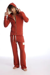 Red hooded zip-up sweatshirt and matching pants set in cinnabar designed for form-fit crossover yoga and performance