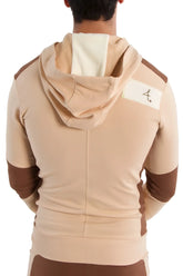Edge form-fit crossover yoga track performance hoodie in sand and chocolate with a white shoulder patch and black logo
