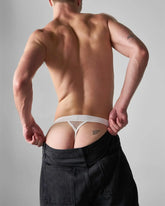 White mesh edge net jock thong with solid waistband and good boy text embroidered on the right side