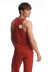 Back view of a red cinnabar edge sustain tank top with a white label featuring sleeveless lightweight fabric