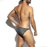 Rear view of a man wearing ES Collection cobalt metallic bloom bikini briefs against a white background.