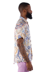 A man wearing an exclusive buzz s s shirt with a blue orange cream paisley pattern on a light background