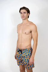 Men’s feather print swim short in vibrant blue and orange leaf pattern stretch fabric with black drawstring waistband