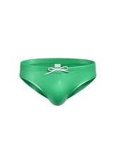 Vibrant green glossy faux leather swim trunks with white drawstring bow from Fizx Swim Bikini with removable push pad