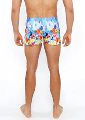 Floral abstract printed swim short featuring vibrant blue orange red and yellow floral pattern for beachwear