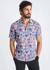 A lightweight linen tencel short-sleeved shirt with a purple blue and pink floral pattern on light lavender background