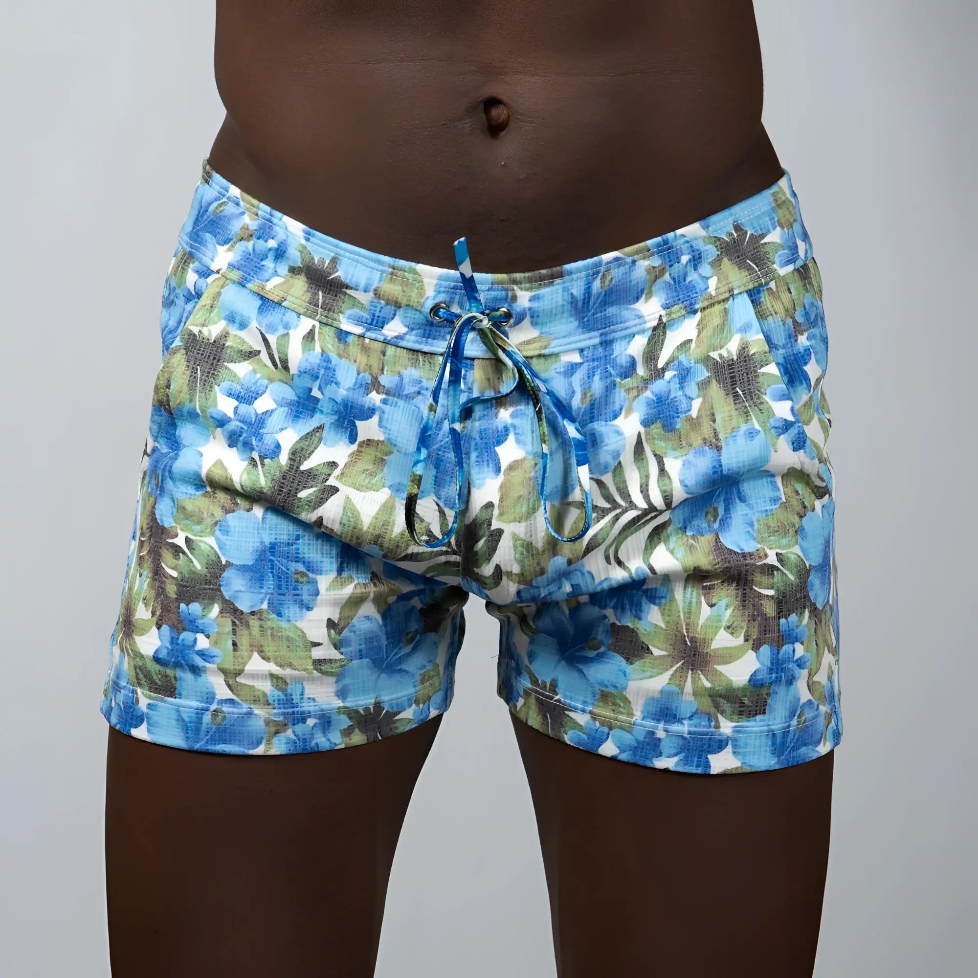 Floral print linen texture shorts in blue and green with a drawstring waistband and floral swim pattern