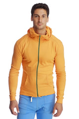 Form-fit crossover yoga track performance hoodie in sun orange with green zipper and two front pockets for activewear