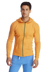 A vibrant sun orange form-fit crossover yoga track performance hoodie with a green zipper and front pockets