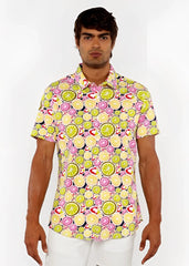 A vibrant short-sleeved fruits print stretch knit shirt with lime and pink citrus slices on a light yellow background