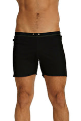 Black fusion yoga short swim trunks with sleek minimalist design and subtle white stitching along the waistband