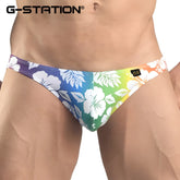 G-station hibiscus bikini underwear men’s swim trunks with vibrant tropical floral pattern on rainbow gradient background