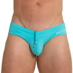 Gigo bottom blue swim brief turquoise swim trunks with drawstring closure and white #bottom branding on waistband