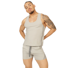 A man wearing a gigo club gray tank sleeveless light gray tank top with subtle side seams