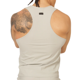 A sleek off-white racerback tank top with minimalist design and small black gigo club brand tag at the neckline